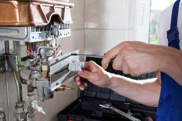 Our plumber checks the equipment after the water damage cleanup